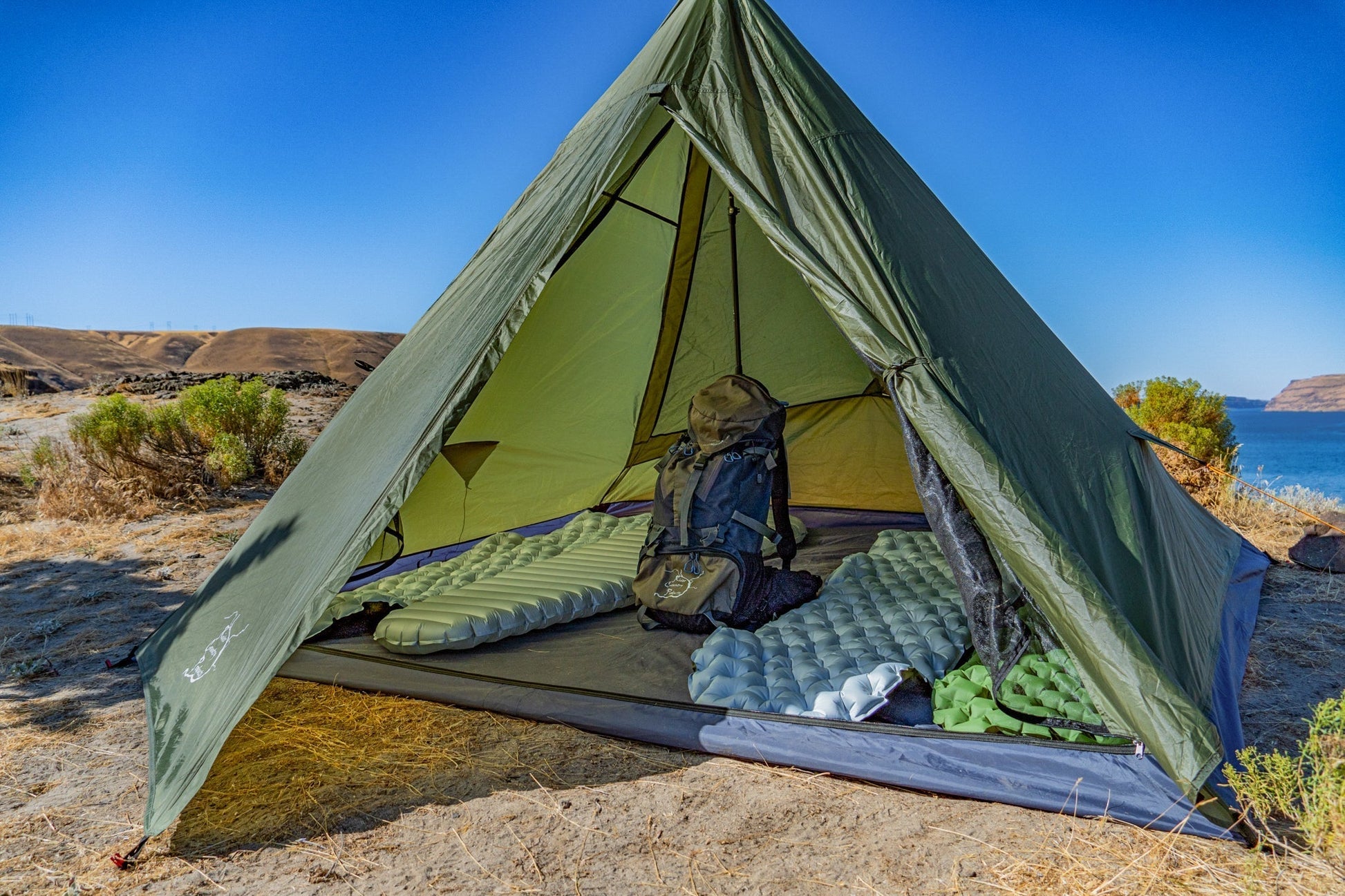 Trekker Tent 4-person by River Country Gear, green pyramid tent with sleeping pads inside on Tampa Home & Garden Store