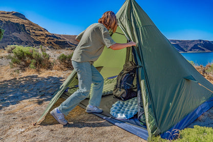 Trekker Tent 4 by River Country Gear green pyramid tent with a hiker entering on Tampa Home & Garden Store