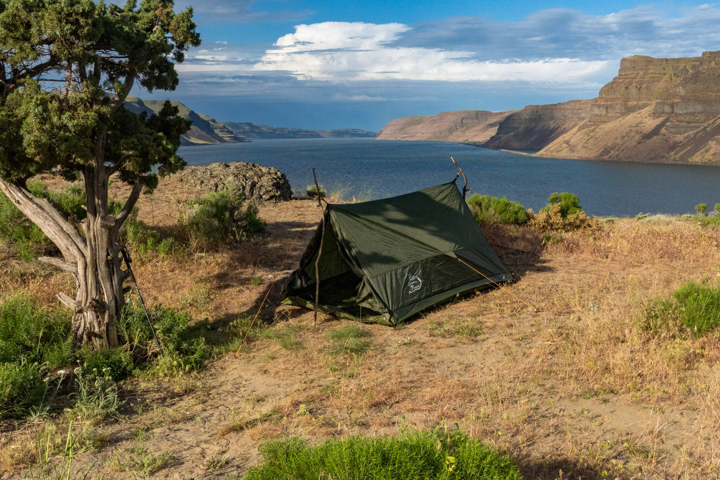 Trekker Tent 2 2-Person Backpacking Tent by River Country Gear in green beside a lake canyon on Tampa Home & Garden Store