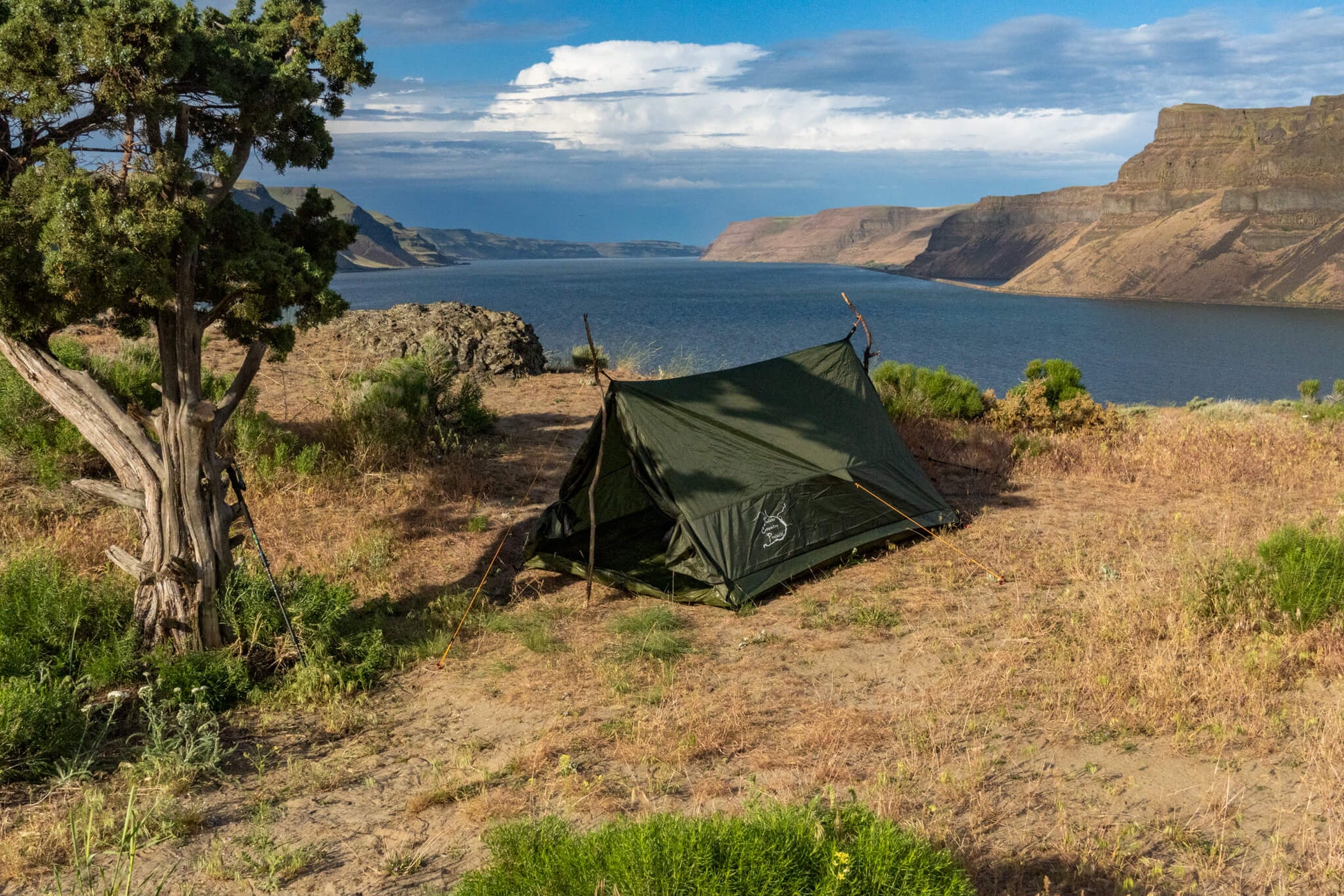Trekker Tent 2 2-Person Backpacking Tent by River Country Gear in green beside a lake canyon on Tampa Home & Garden Store