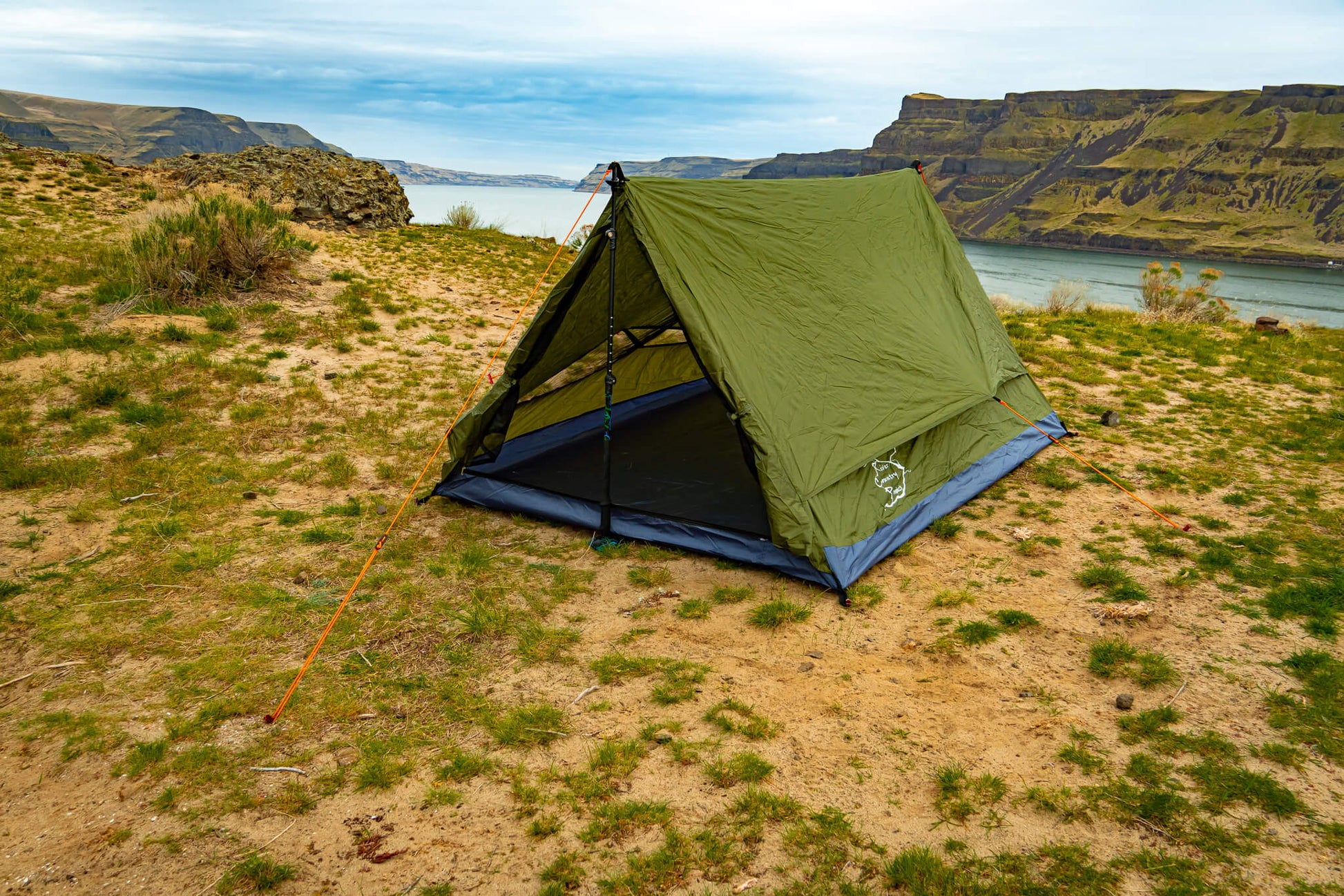 Trekker Tent 2.2 green 2-person backpacking tent by River Country Gear pitched sandy shore on Tampa Home & Garden Store
