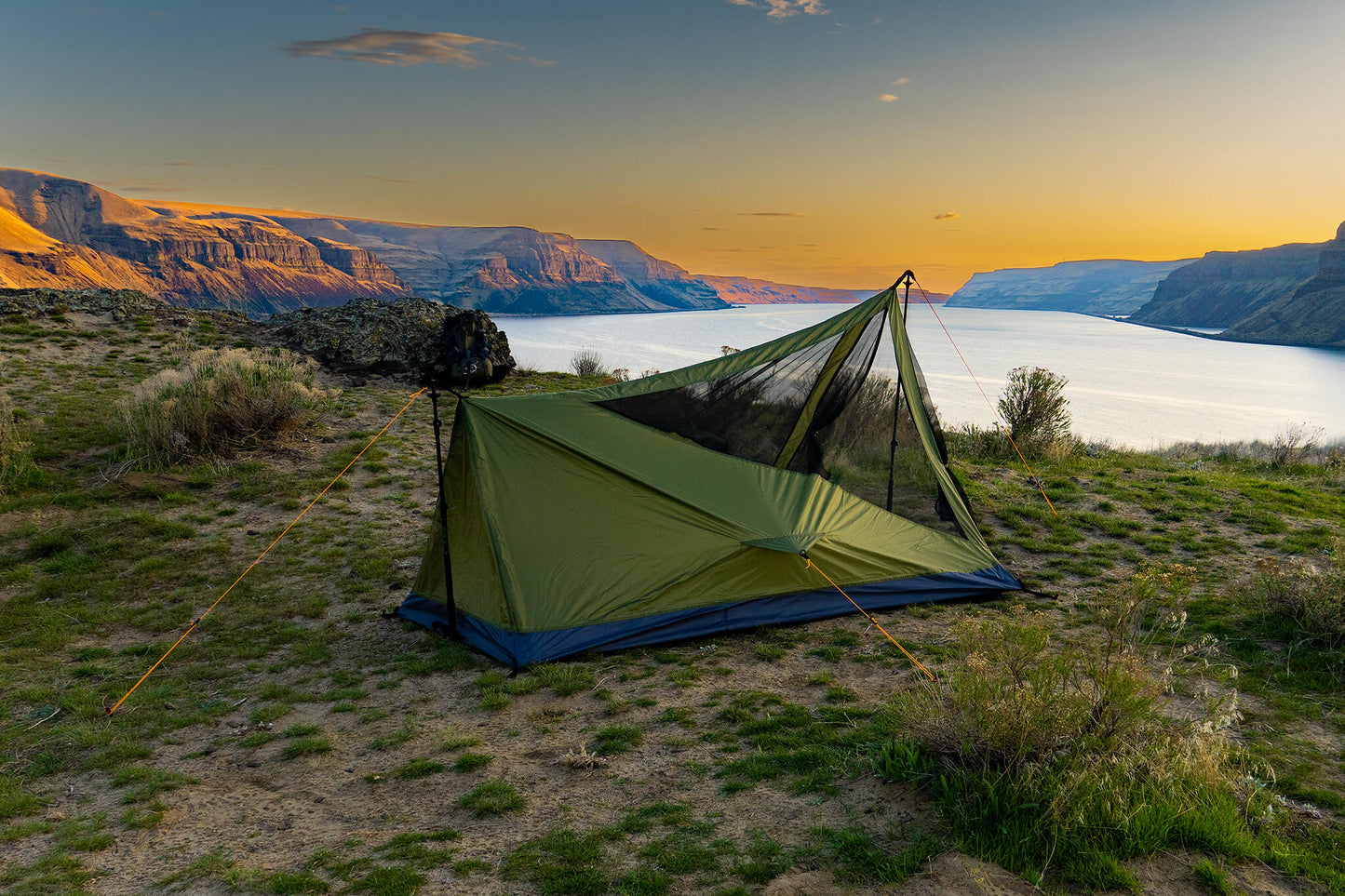 Trekker Tent 2V by River Country Gear, green 2-person backpacking tent by a lake at sunset on Tampa Home & Garden Store
