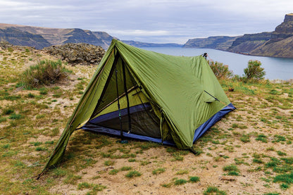 River Country Gear Trekker Tent 2V, green 2-person backpacking tent on ground by a lake on Tampa Home & Garden Store
