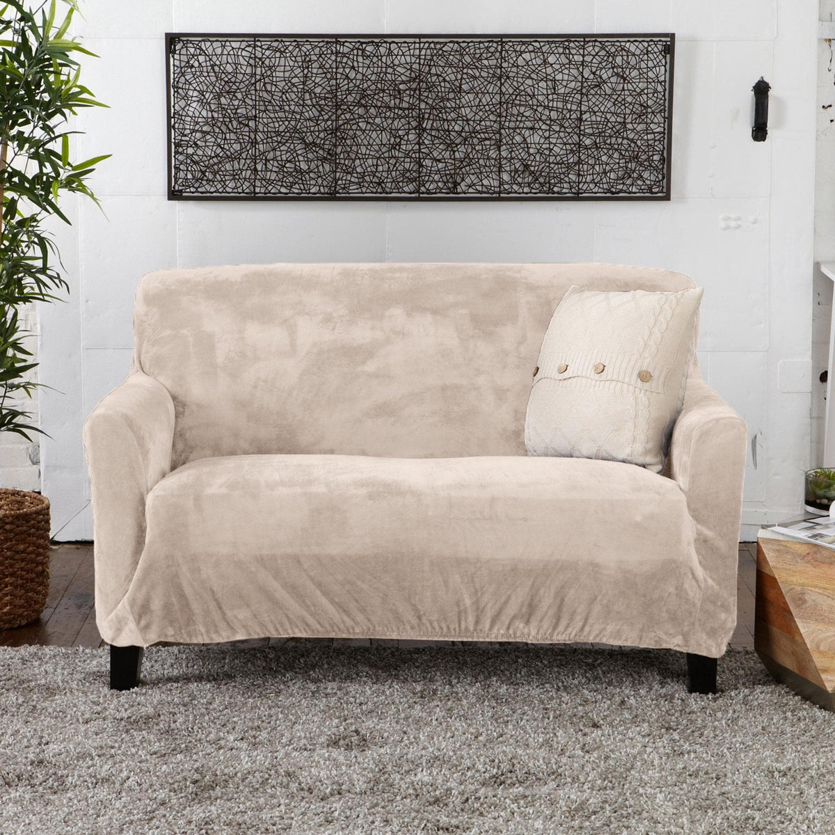 Velvet Stretch Slipcover Gale Collection beige sofa slipcover with dark wooden legs on Tampa Home & Garden Store