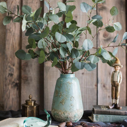 Turquoise ceramic vase by RusticReach with eucalyptus stems in a rustic wooden setting on Tampa Home & Garden Store