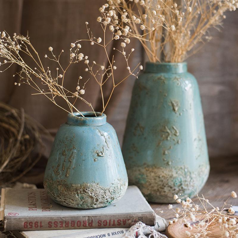 Turquoise ceramic vases by RusticReach; two aged vessels with baby's breath on stack on Tampa Home & Garden Store