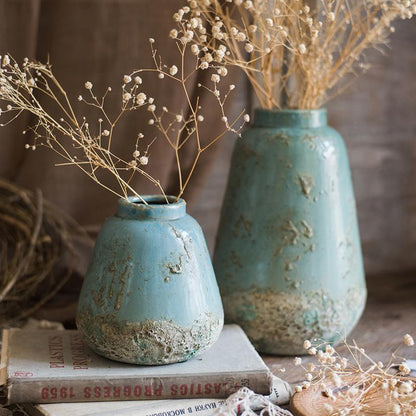 Turquoise ceramic vases by RusticReach; two aged vessels with baby's breath on stack on Tampa Home & Garden Store