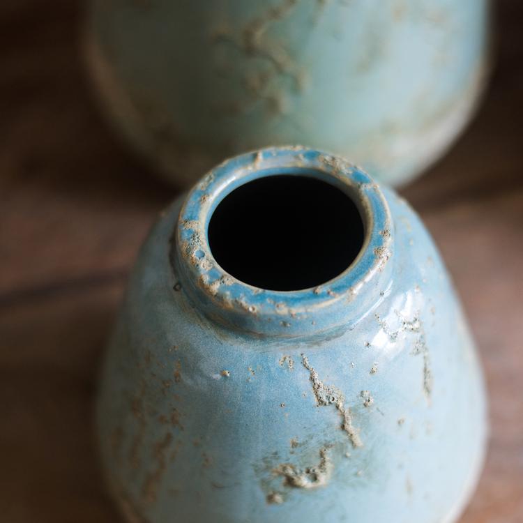 Two turquoise ceramic vases by RusticReach with weathered blue glaze and rough, chipped finish on Tampa Home & Garden Store