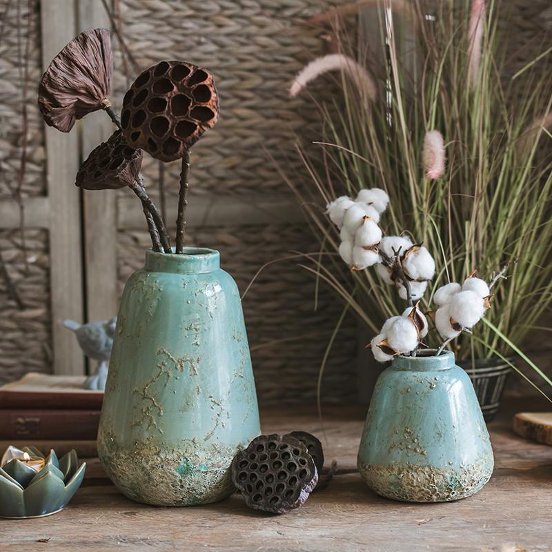 Pair of turquoise ceramic vases by RusticReach with rustic finish and dried lotus pods on Tampa Home & Garden Store