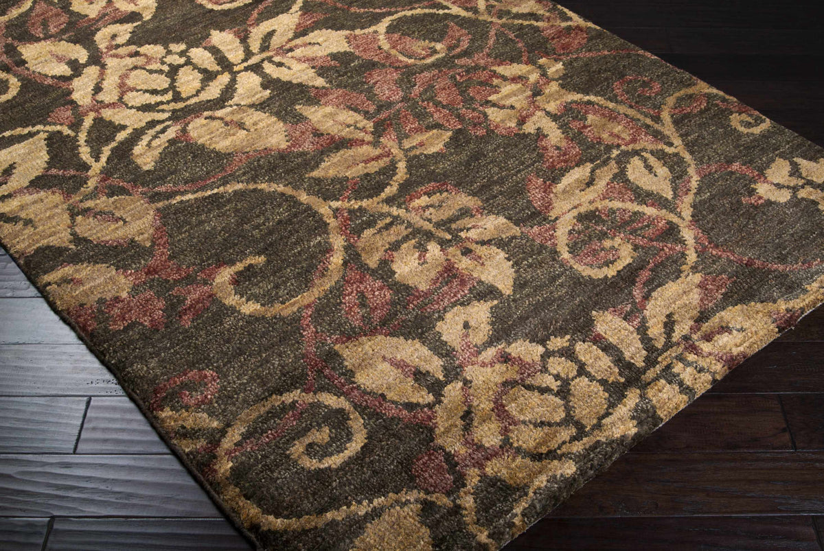 Uhland Jute Carpet rug with earthy beige, tan, and burgundy floral motifs on dark backdrop on Tampa Home & Garden Store
