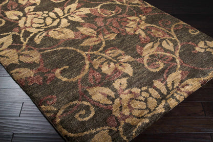 Uhland Jute Carpet rug with earthy beige, tan, and burgundy floral motifs on dark backdrop on Tampa Home & Garden Store