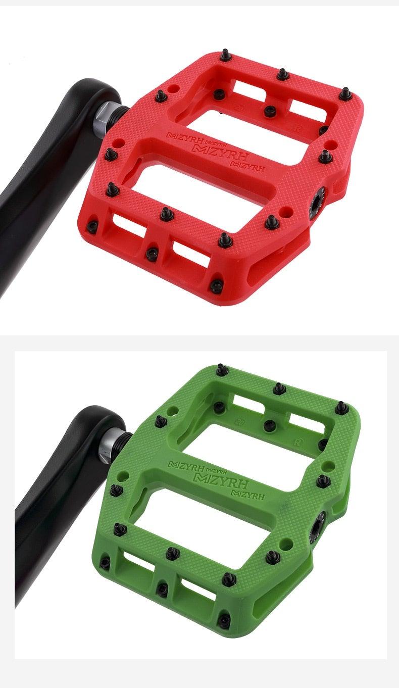 Stevvex ultralight flat bicycle pedals in red and green with black non-slip studs and machined alloy body on Tampa Home & Garden Store