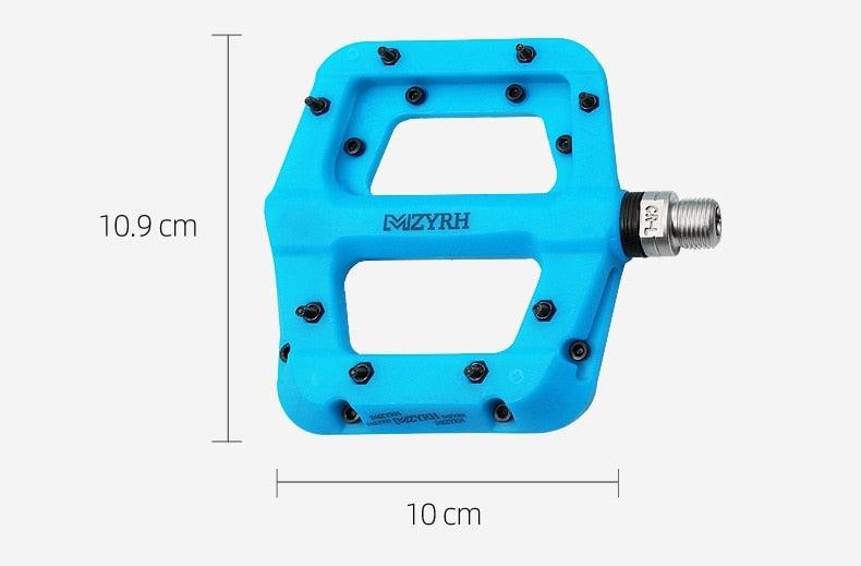 Flat blue nylon bicycle pedals by Stevvex with non-slip grip and MIZYRH logo on alloy body on Tampa Home & Garden Store