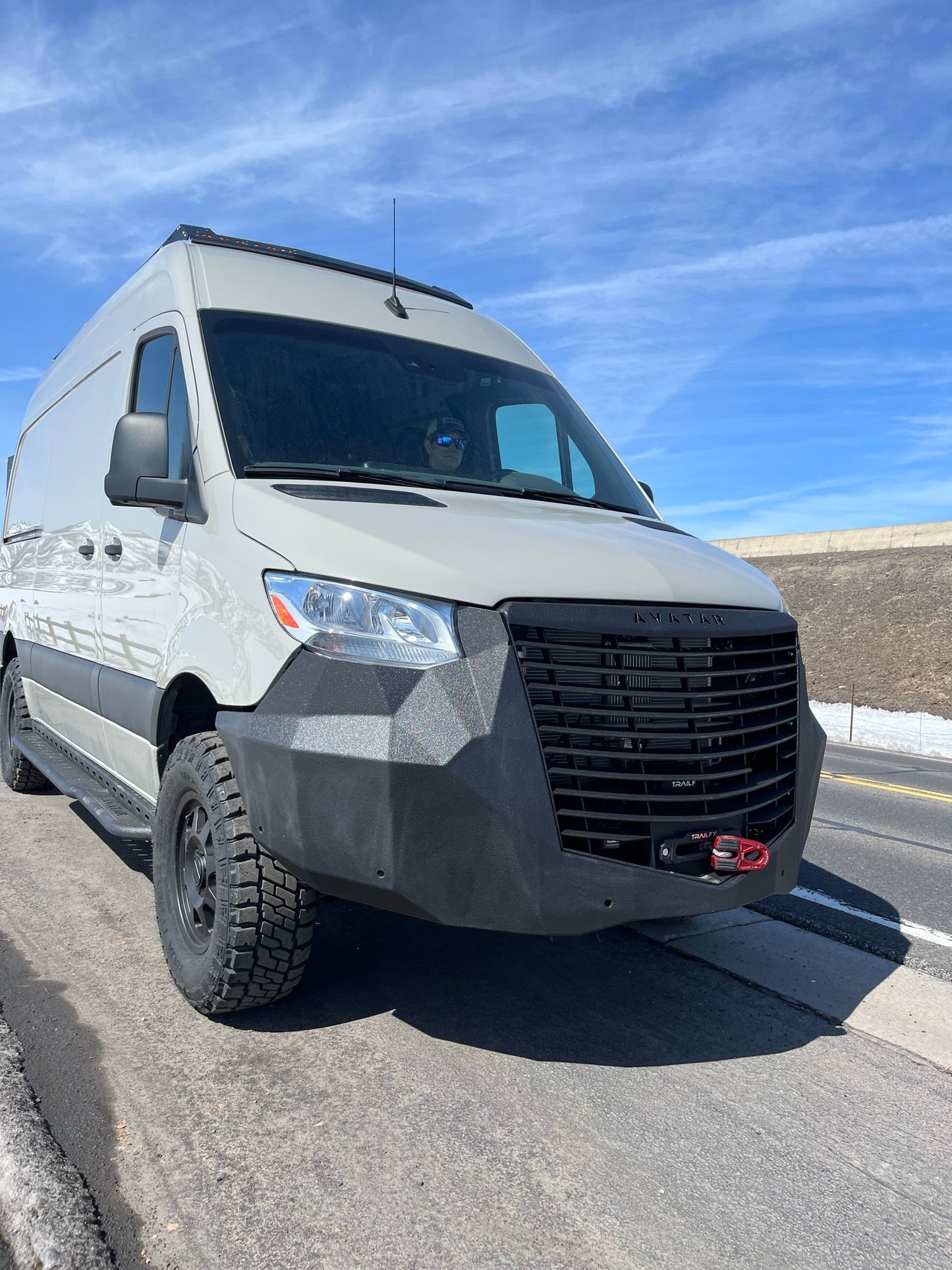 The Ultra Rack low-profile black roof rack on a white Sprinter van by avatar offroad on Tampa Home & Garden Store