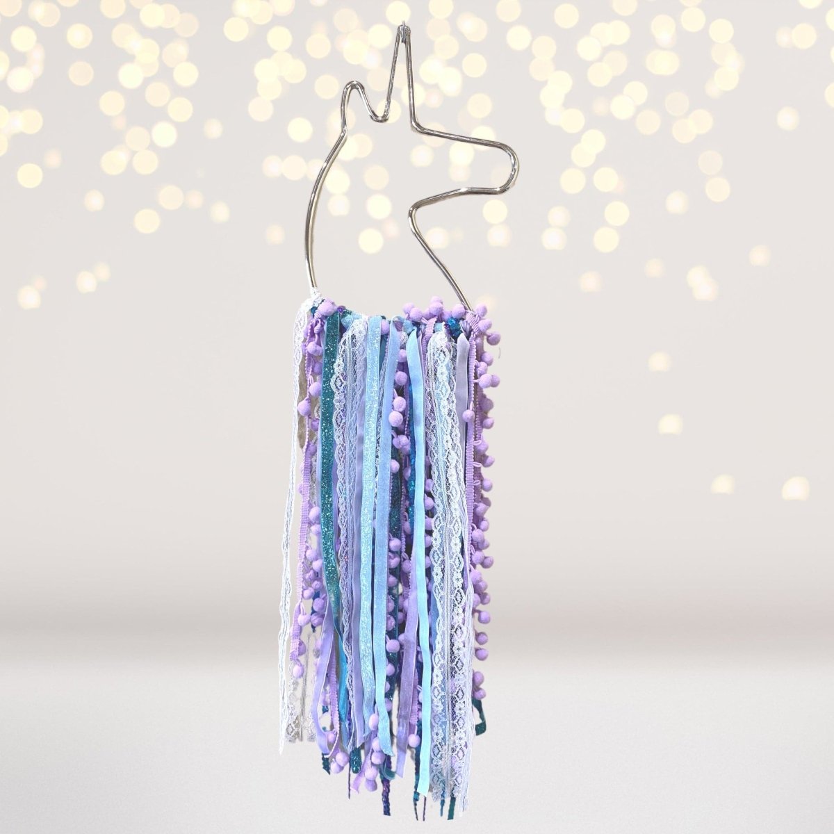 Unicorn dream catcher with pastel ribbons, lace and purple pom pom fringe on Tampa Home & Garden Store