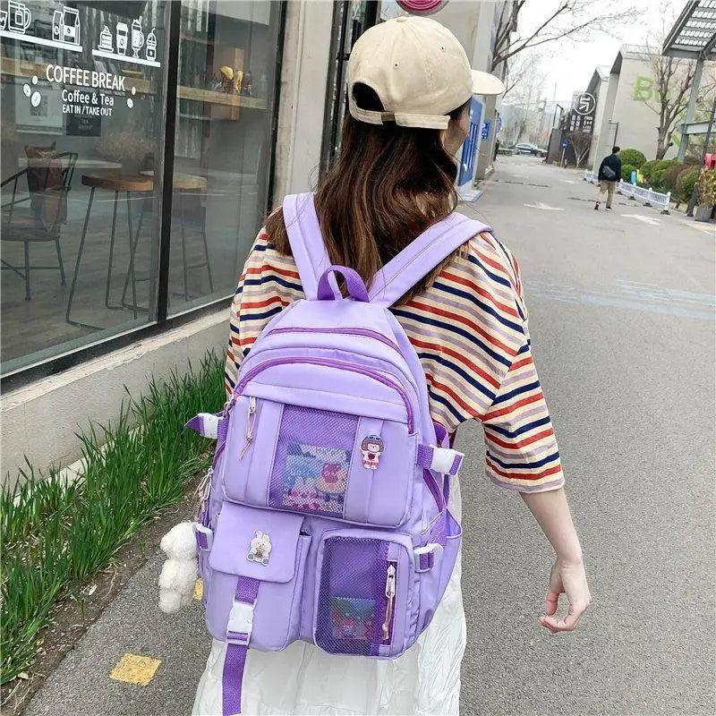 Stevvex ALU92981RST purple multi-pocket school backpack with large capacity worn by girl on Tampa Home & Garden Store