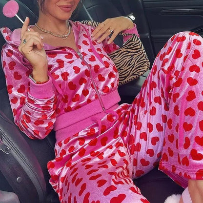 Velvet heart-print loungewear set with zip hoodie and matching pants in pink on model in car on Tampa Home & Garden Store