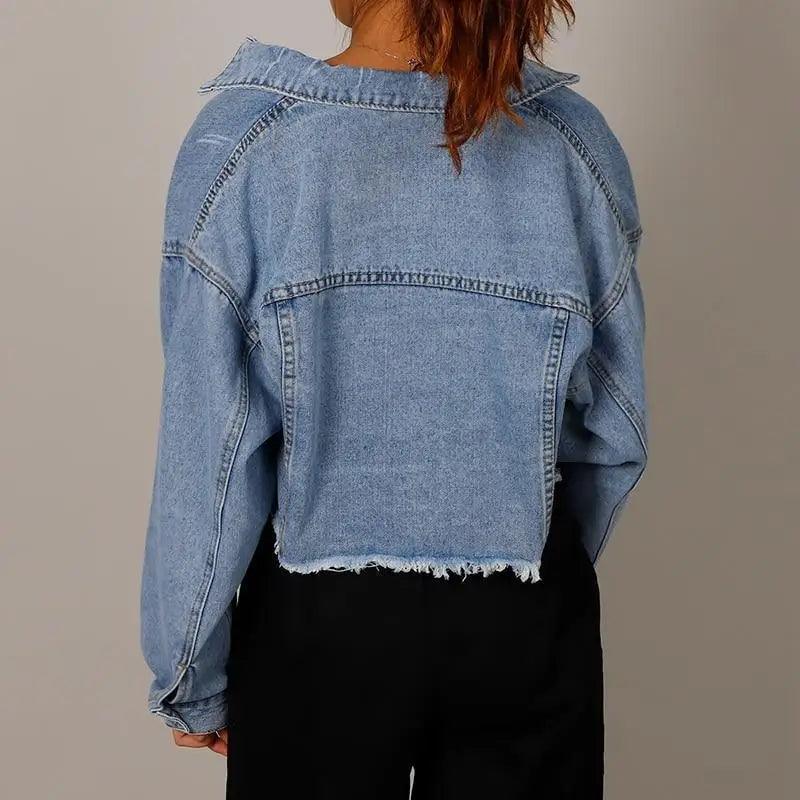 Women's light-wash cropped denim trucker jacket with frayed hem, back view on Tampa Home & Garden Store