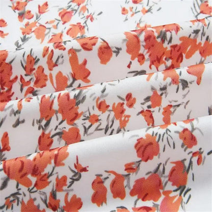 Floral printed bomber jacket fabric in white with orange-red flowers and gray stems Stevvex on Tampa Home & Garden Store