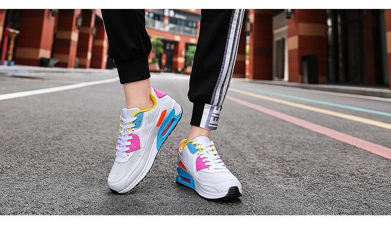 Stevvex unisex air cushion sneakers in white with pink, blue, yellow accents on street on Tampa Home & Garden Store