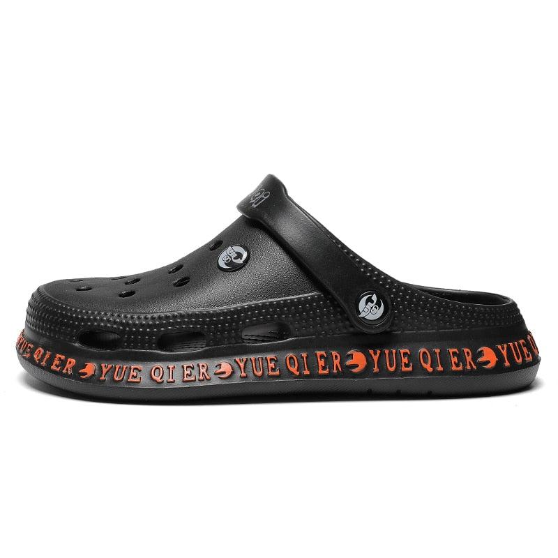 Unisex black Stevvex slip-on sandals with breathable perforated upper and orange sole on Tampa Home & Garden Store