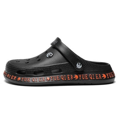 Unisex black Stevvex slip-on sandals with breathable perforated upper and orange sole on Tampa Home & Garden Store