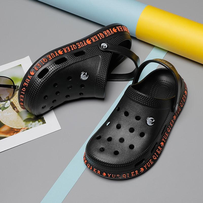 Stevvex black perforated slip-on sandals pair with back strap, orange sole beach slippers on Tampa Home & Garden Store