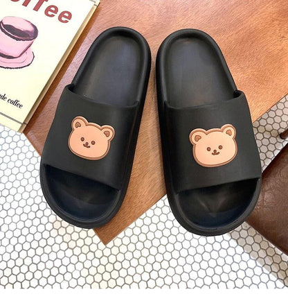 Unisex thick-sole black slides pair by Stevvex with beige bear logos on straps on Tampa Home & Garden Store