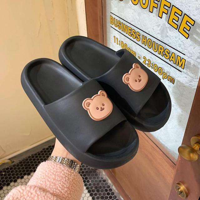 Unisex Stevvex thick-sole slides in black with peach bear logo, pair of sandals on Tampa Home & Garden Store