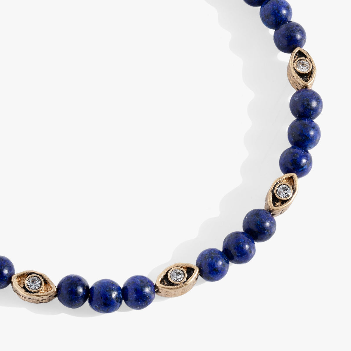Untamed Evil Eye Lapis Bangle with blue lapis beads and gold-tone eye charms with crystals on Tampa Home & Garden Store