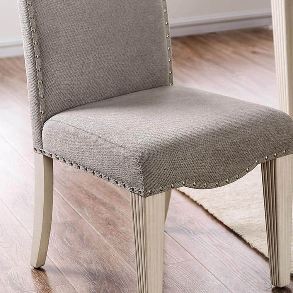 Upholstered dining chair with camel back, grey fabric, nailhead trim and light wood legs on Tampa Home & Garden Store