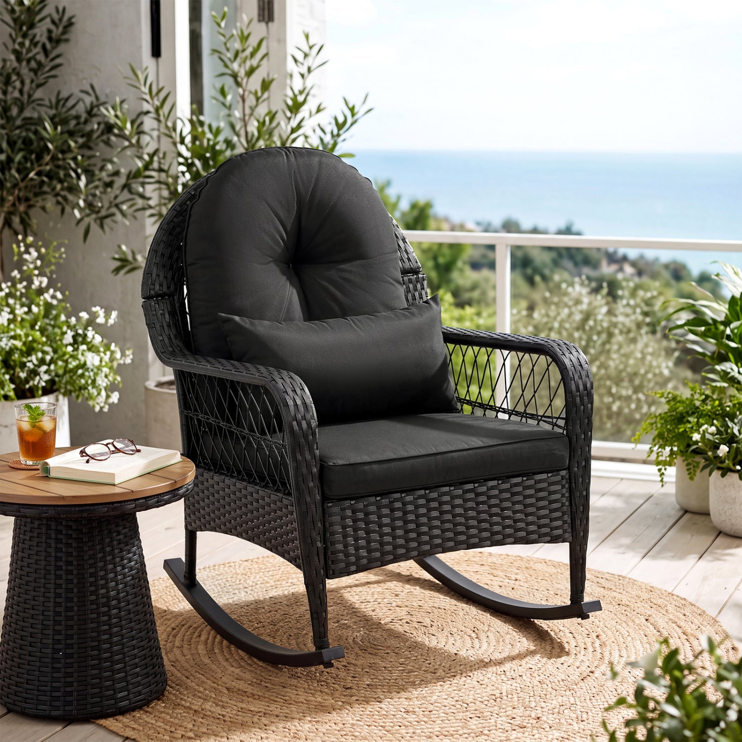 Outdoor wicker rocking chair with black cushions and antitip stoppers by DirectDeals on a patio on Tampa Home & Garden Store