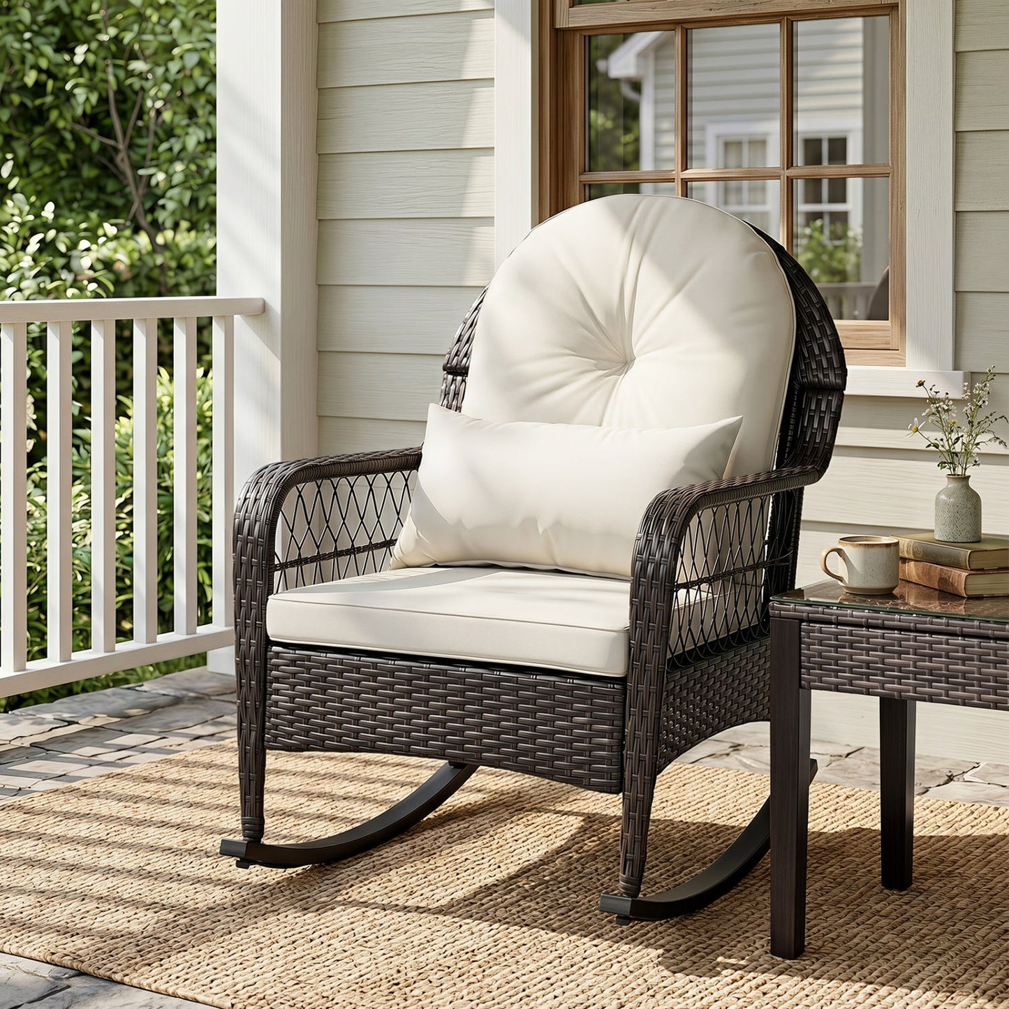 Outdoor wicker rocking chair with cream cushions on a porch, dark brown woven frame on Tampa Home & Garden Store