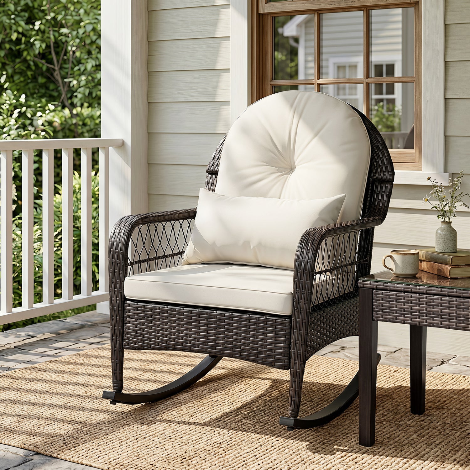 Outdoor wicker rocking chair with cream cushions on a porch, dark brown woven frame on Tampa Home & Garden Store