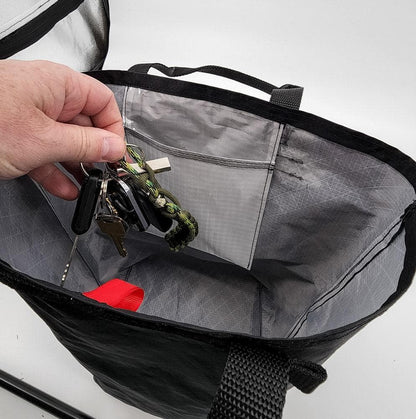 Utility Tote 32L ECOPAK black exterior gray interior with keychain and paracord in pocket on Tampa Home & Garden Store