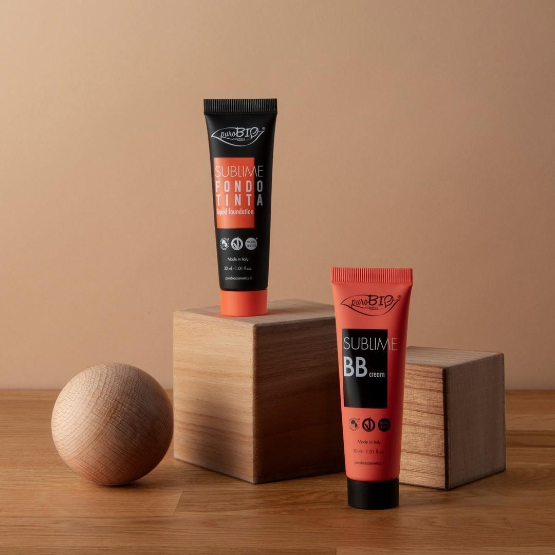 Two PuroBio Sublime foundation and BB cream tubes in coral packaging on wooden blocks on Tampa Home & Garden Store