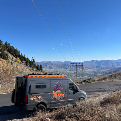 Pioneer Sprinter Roof Rack on avatar offroad van with orange rooftop rack and mountain backdrop on Tampa Home & Garden Store