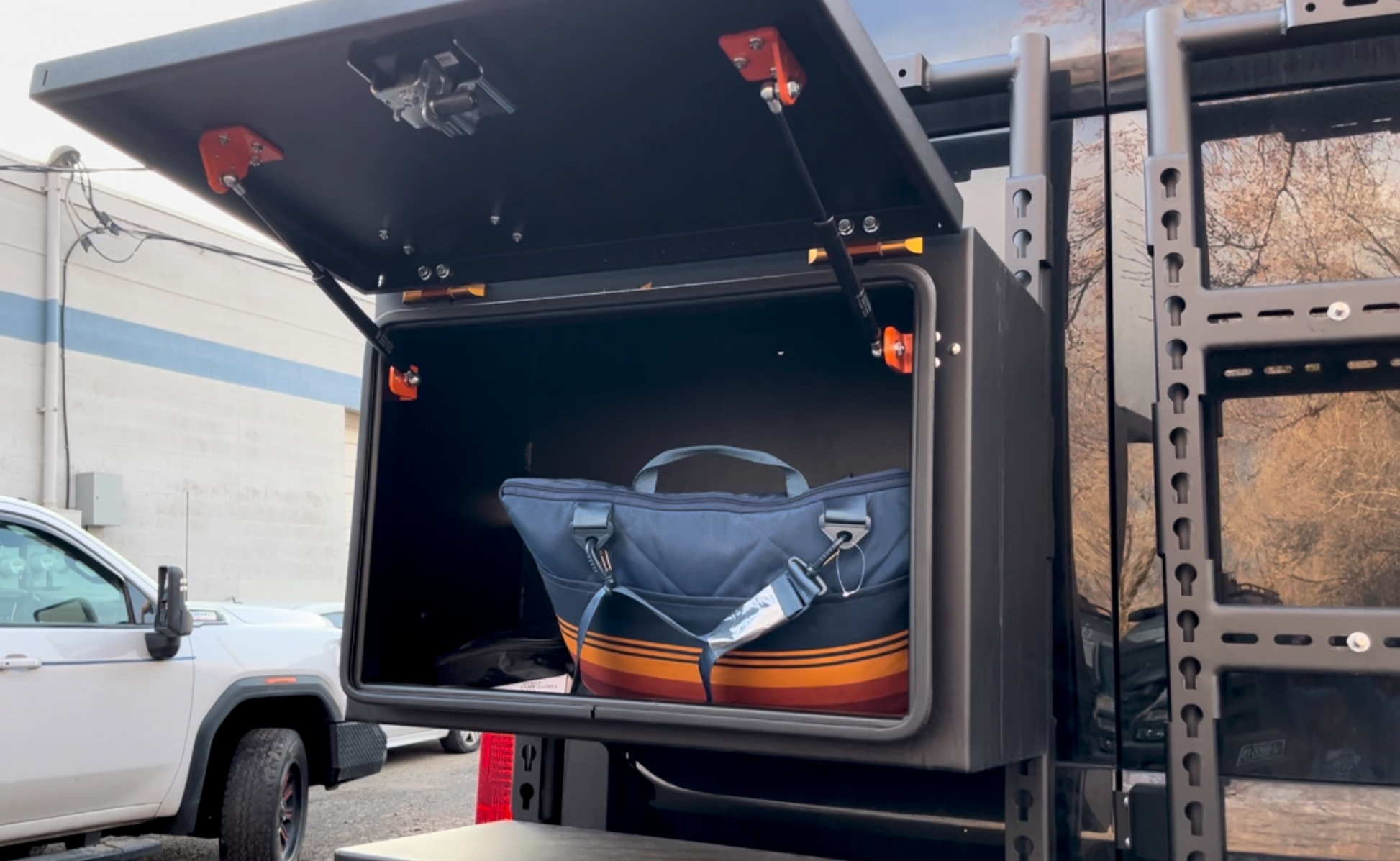 Avatar Offroad Deka Box Small Rear Door Storage mounted on back of vehicle, black box with orange hardware on Tampa Home & Garden Store