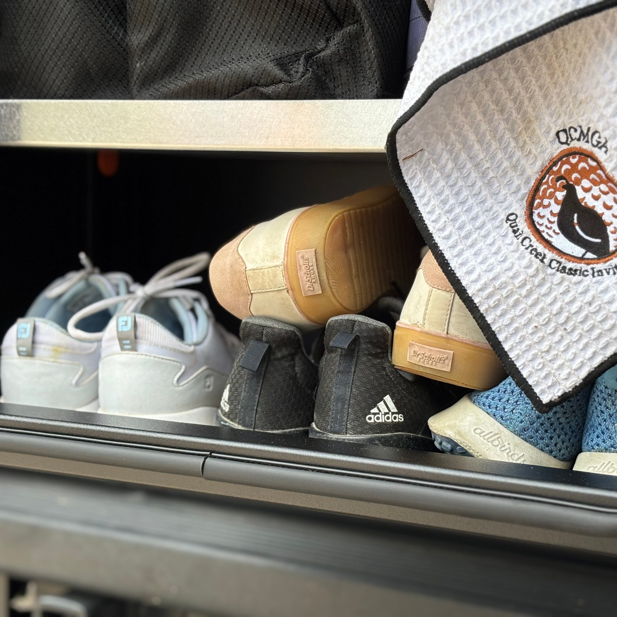 Avatar Caddie Storage Box with gray quilted lid visible beside golf shoes in a car trunk on Tampa Home & Garden Store