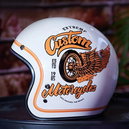 Fiberglass retro open-face helmet in white with orange winged wheel graphic on Tampa Home & Garden Store