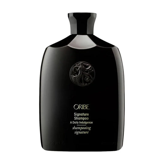 Oribe Signature Shampoo bottle black glossy plastic with embossed crest and gold lettering on Tampa Home & Garden Store