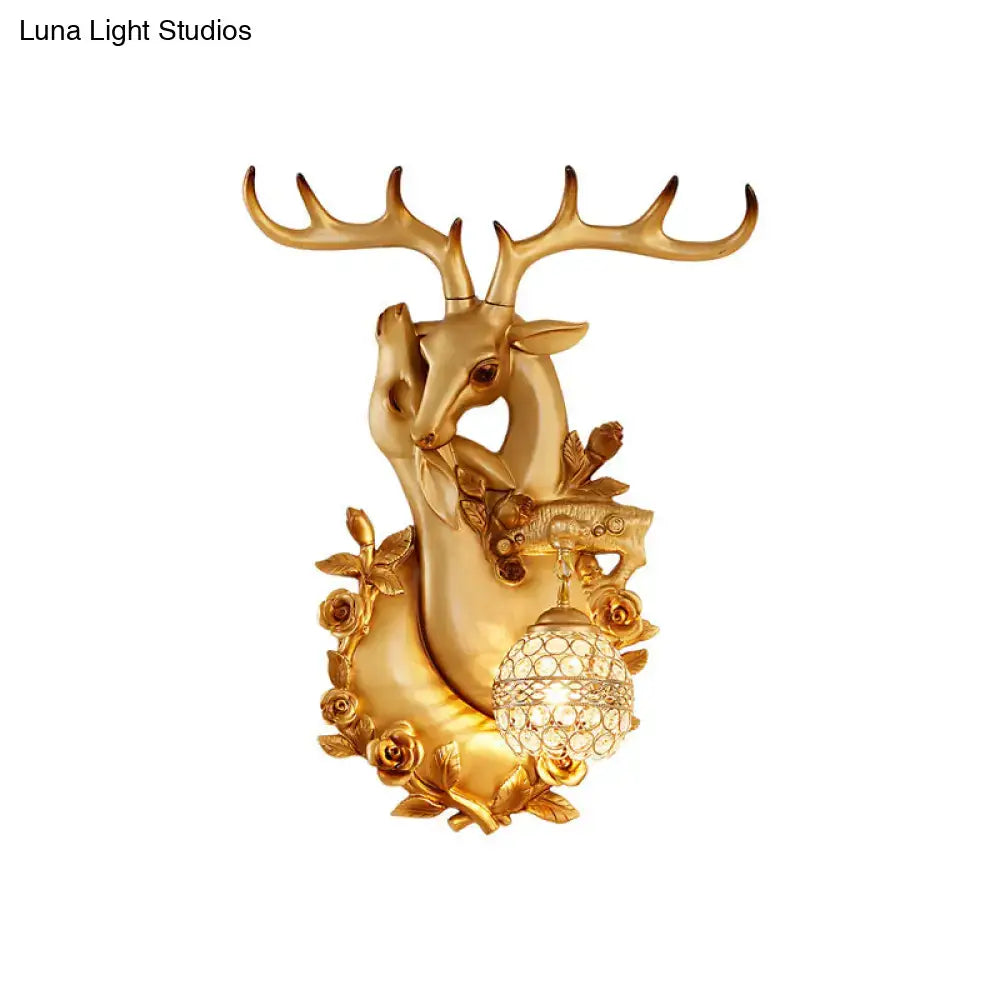 Gold resin deer head sconce from Decorbites with crystal globe lamp and floral accents on Tampa Home & Garden Store
