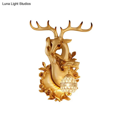 Gold resin deer head sconce from Decorbites with crystal globe lamp and floral accents on Tampa Home & Garden Store