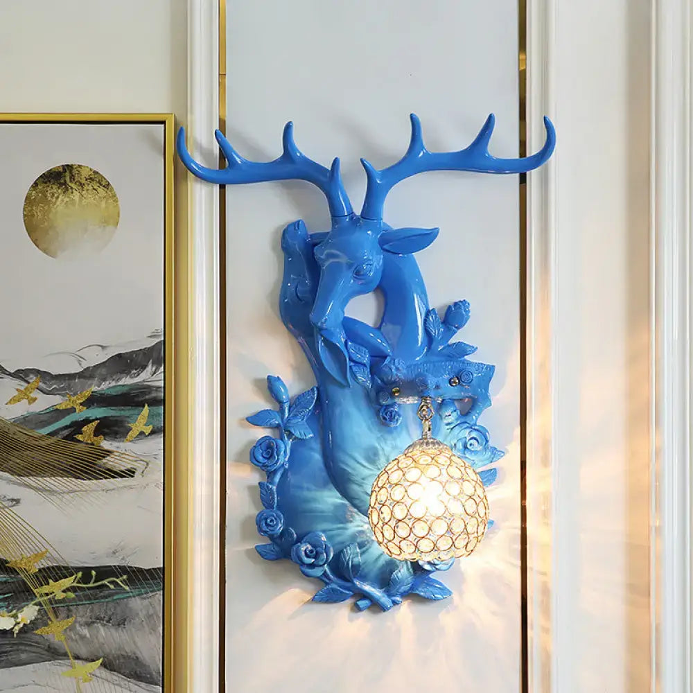Blue resin deer head wall sconce with floral details and honeycomb globe by Decorbites on Tampa Home & Garden Store