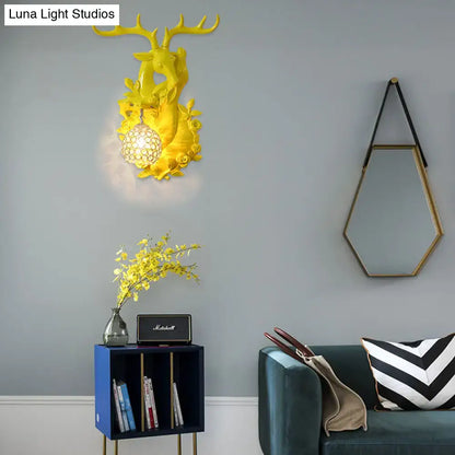 Decorbites gold deer crystal resin wall sconce with hanging crystal orb on gray wall on Tampa Home & Garden Store