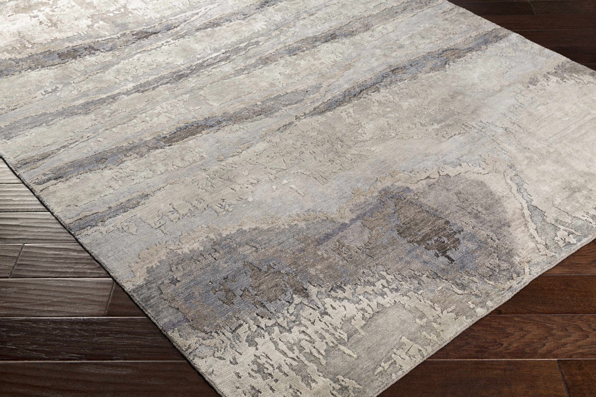 Vincentown Area Rug by Boutique Rugs in gray ivory abstract pattern on wood floor on Tampa Home & Garden Store