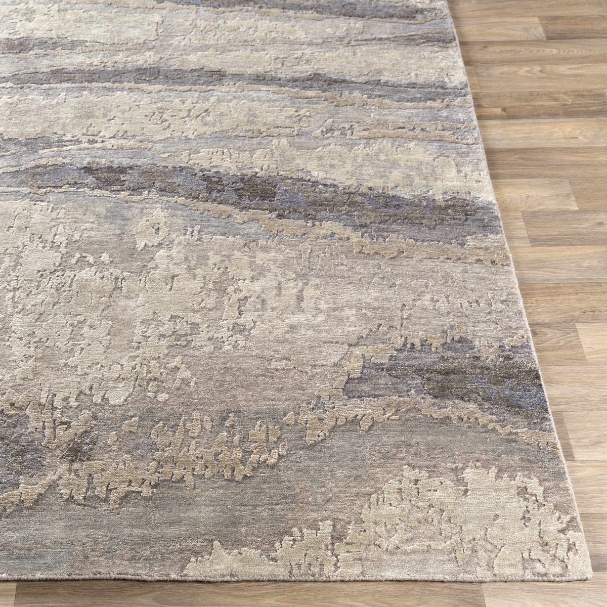 Vincentown Area Rug by Boutique Rugs in gray taupe abstract pattern on wood floor on Tampa Home & Garden Store