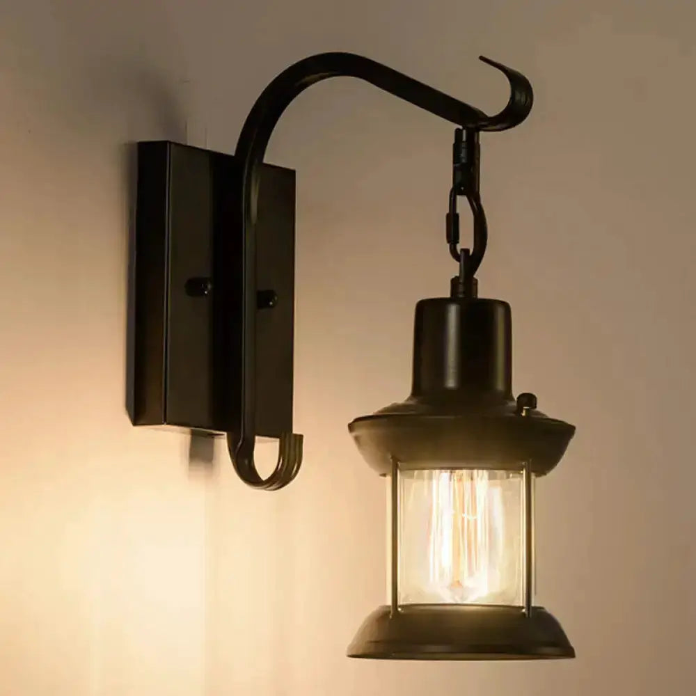 Vintage black lantern wall sconce by Decorbites featuring a curved arm and glass lantern on Tampa Home & Garden Store