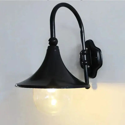 Vintage black Decorbites outdoor wall lamp sconce with curved arm and clear glass shade on Tampa Home & Garden Store