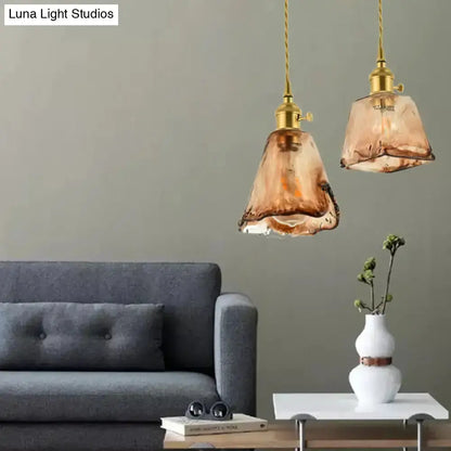 Vintage brass amber glass shaded drop pendant pair above living room sofa on Tampa Home & Garden Store